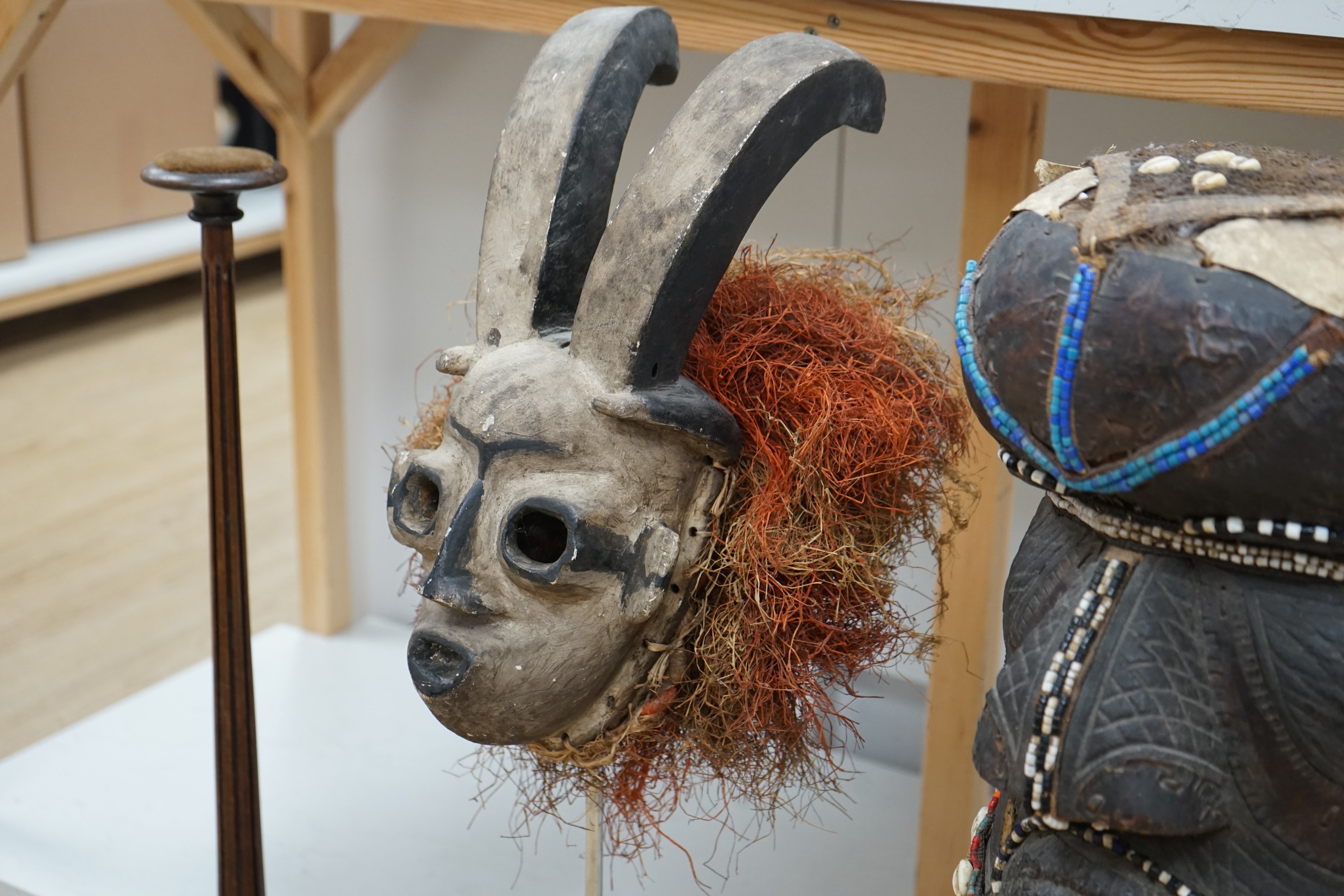 An African Kuba helmet mask and another horned mask, both on stands & one spare. Condition - helmet mask damaged